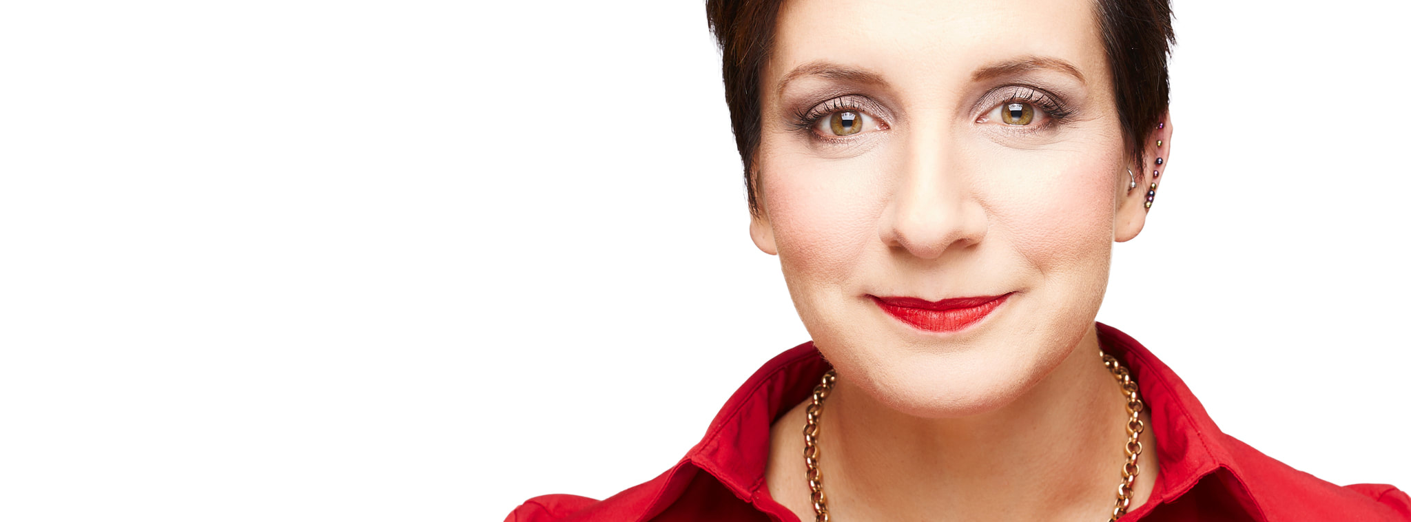 Portrait of Naomi Malouf, smiling, wearing a red shirt